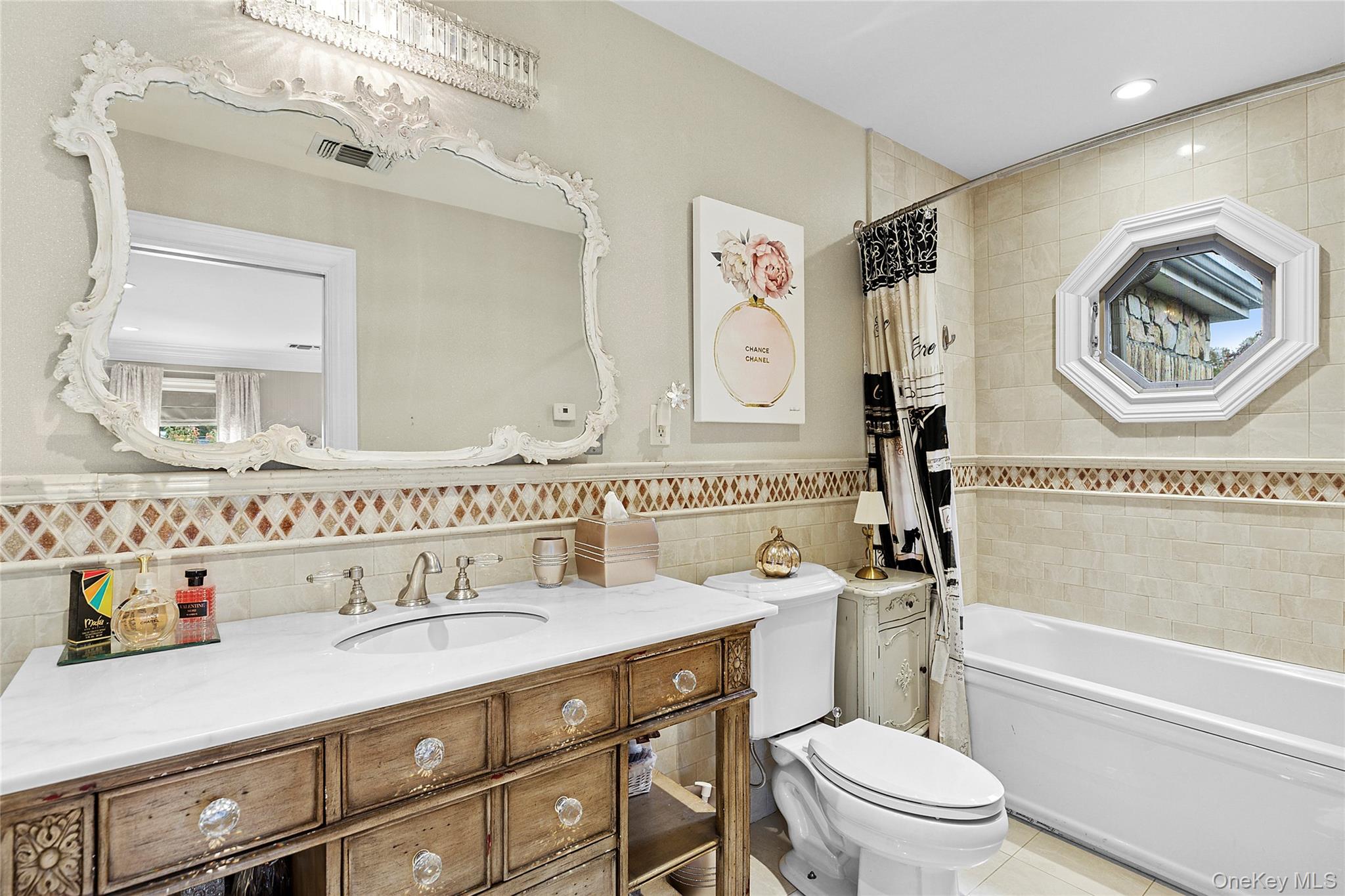 5 Schoolhouse Court Oyster Bay, NY 11771 - Photo 17 of 33 a bathroom with a sink a toilet and a mirror