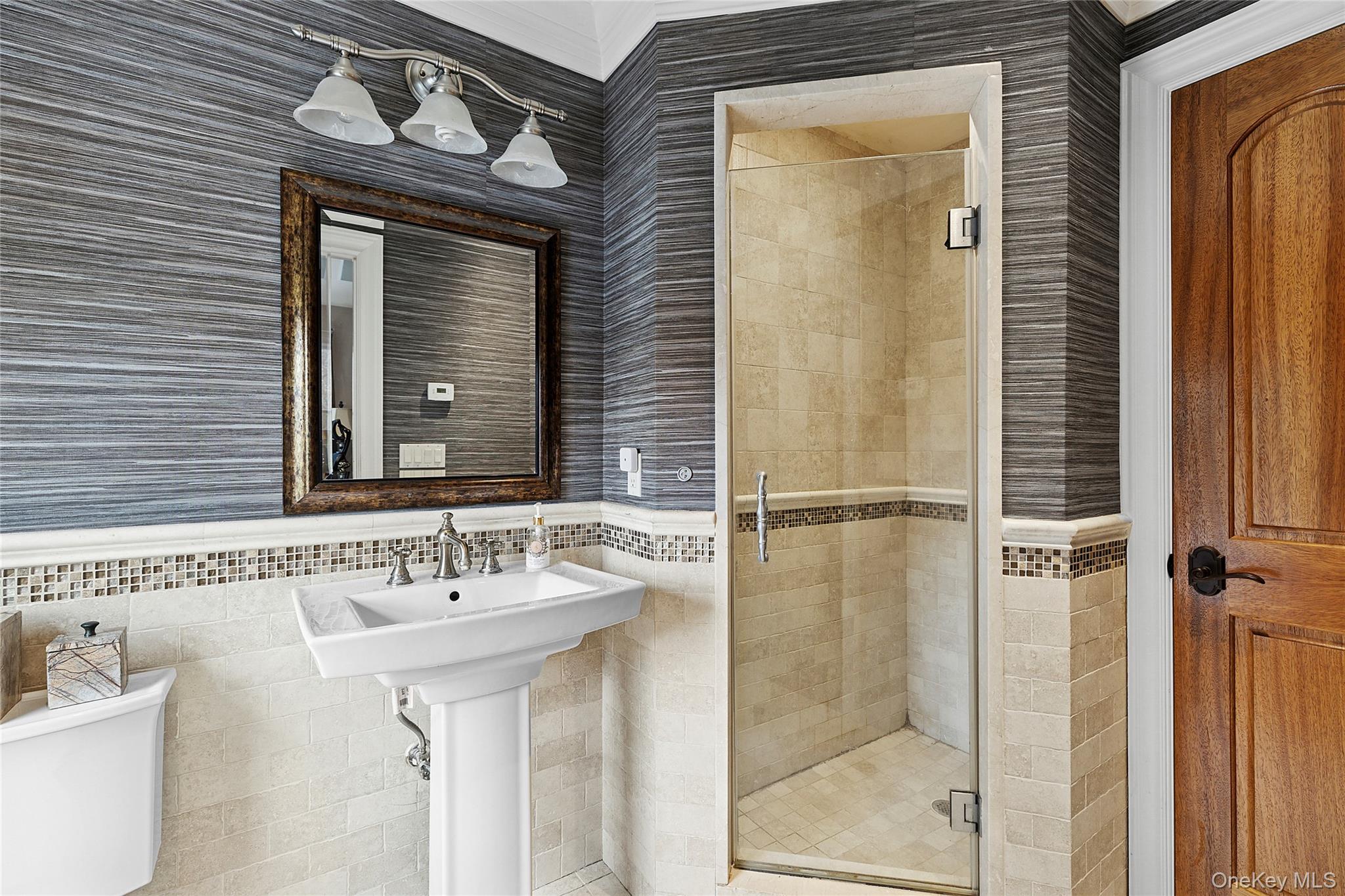 5 Schoolhouse Court Oyster Bay, NY 11771 - Photo 19 of 33 a bathroom with a sink and a mirror