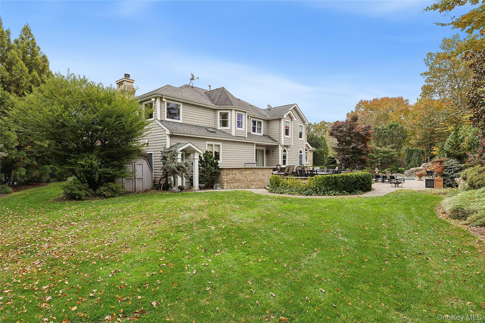 5 Schoolhouse Court Oyster Bay, NY 11771 - Photo 30 of 33 a front view of a house with garden