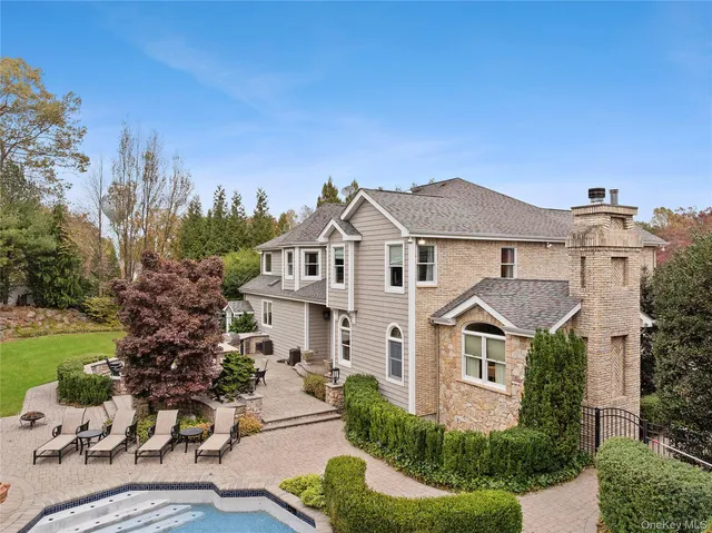 an aerial view of residential house with yard and swimming pool