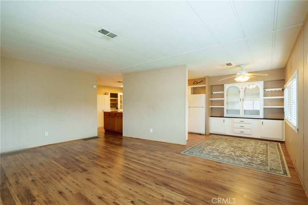 4000 Pierce Street, Unit 72 Riverside, CA 92505 - Photo 8 of 20 an empty room with wooden floor and windows