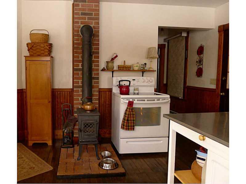 14 Adams Street Wilton, ME 04294 - Photo 4 of 24 Kitchen. The woodstove adds to the...