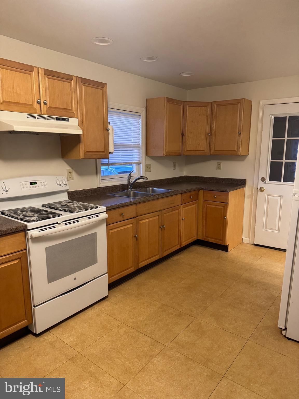 4594 Post Road Vineland, NJ 08360 - Photo 2 of 7 a kitchen with stainless steel appliances granite countertop a stove a sink and a refrigerator