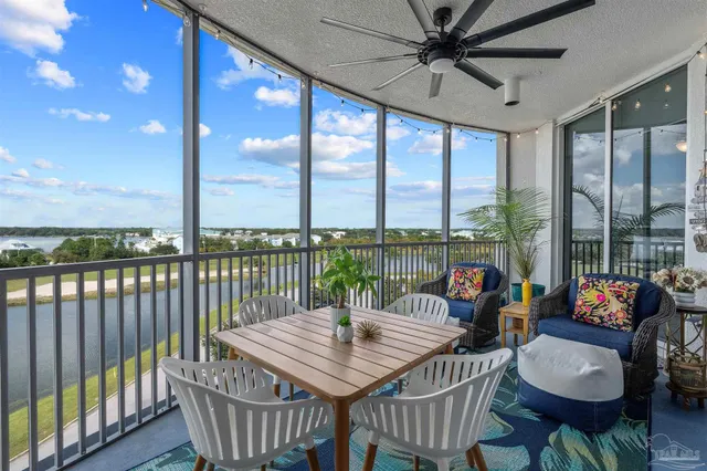 a living room with furniture kitchen view and a large window