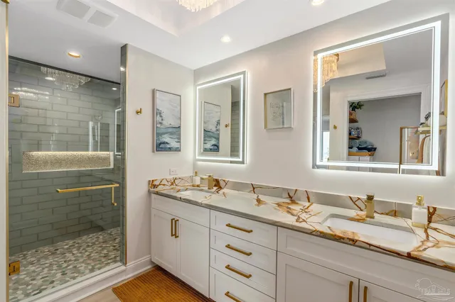 a bathroom with a granite countertop toilet a sink and mirror