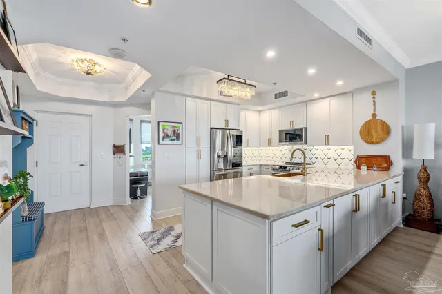 a kitchen with stainless steel appliances granite countertop a sink stove and cabinets