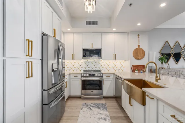 a kitchen with stainless steel appliances granite countertop a refrigerator sink and stove