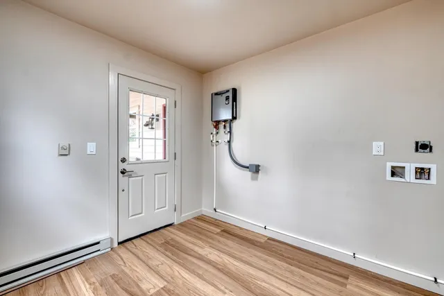 a living room with furniture and a floor to ceiling window