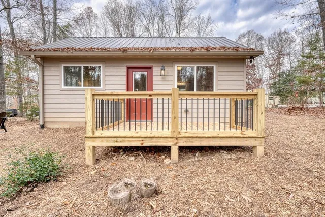 a white house that has a tree in front of it
