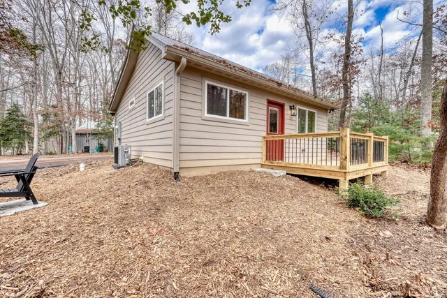 a backyard of a house with table and chairs