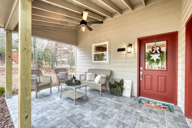 a kitchen with stainless steel appliances kitchen island granite countertop a refrigerator a stove a sink dishwasher a dining table and chairs with wooden floor