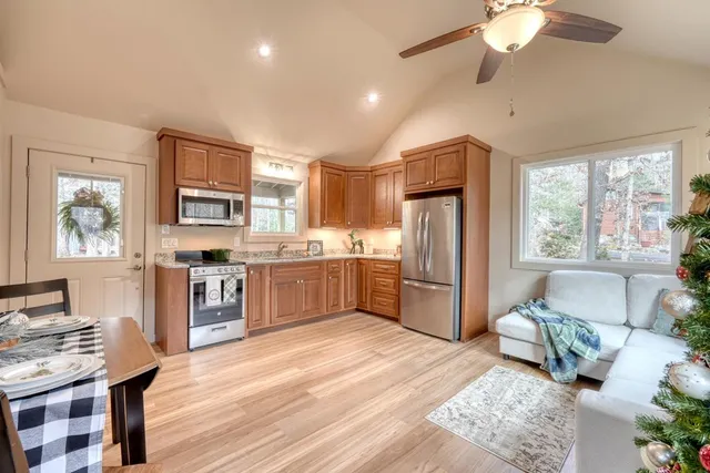 a living room with furniture a chandelier and a window