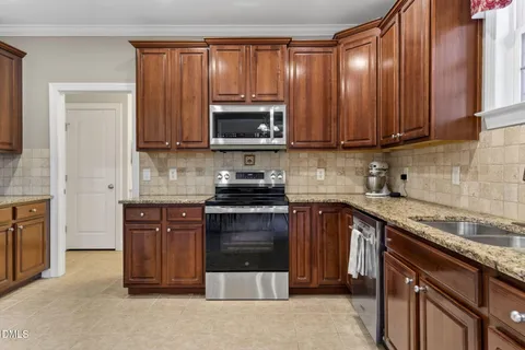 a view of kitchen with furniture and refrigerator