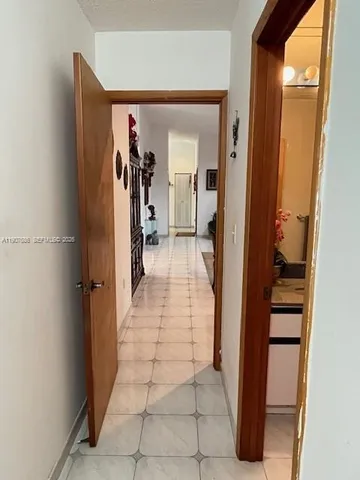 a kitchen with kitchen island granite countertop a sink a stove and cabinets