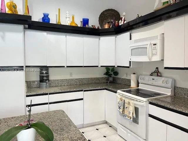 a kitchen with a sink a stove and cabinets