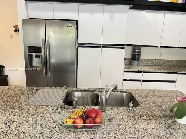 a kitchen with kitchen island a sink and wooden cabinets