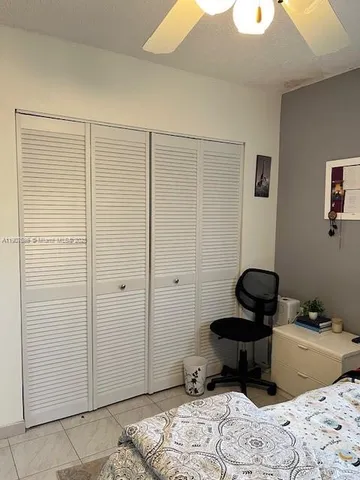 a view of a bedroom with a bed and a window