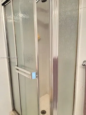 a bathroom with a granite countertop bathtub shower and toilet