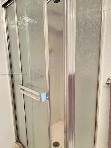 a bathroom with a granite countertop bathtub shower and toilet