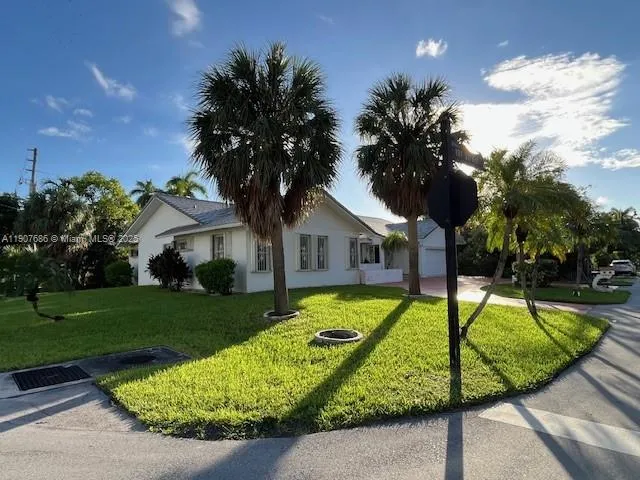 a view of a house with swimming pool and a small yard