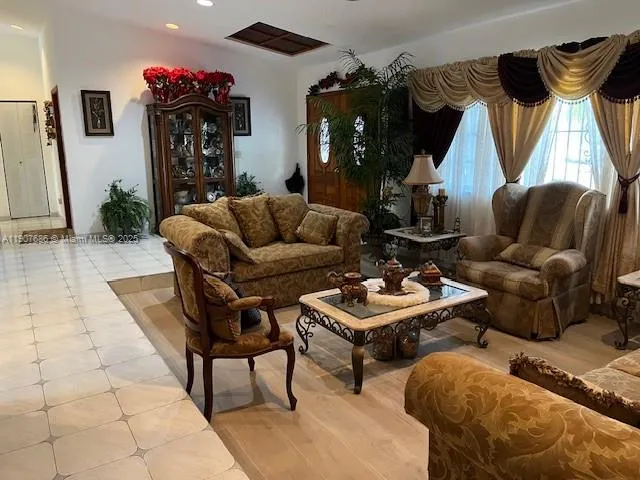 a living room with furniture a couch and a chandelier