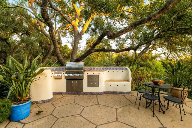 a view of a chairs and table in the backyard