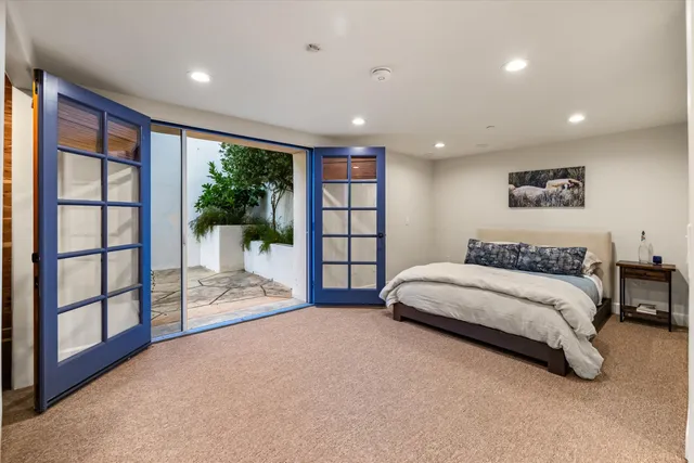 a spacious bedroom with a large bed and a large window