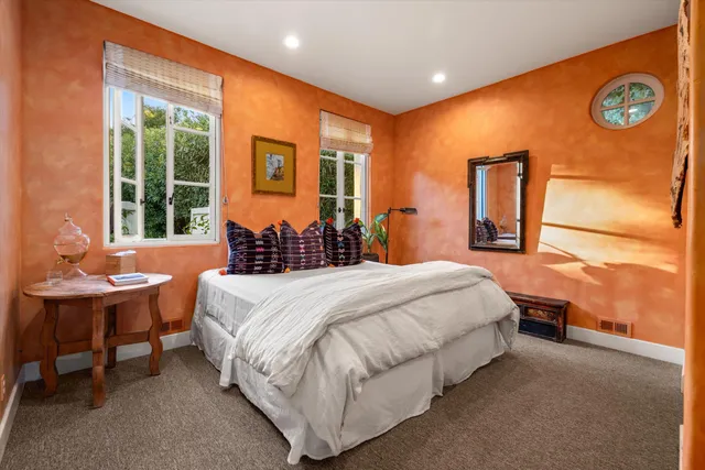 a bedroom with a bed and a table with chair