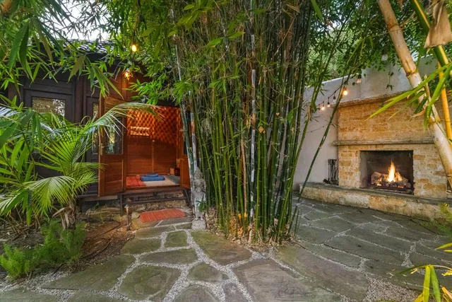 a backyard of a house with table and chairs