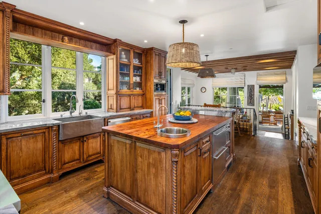 a kitchen with stainless steel appliances granite countertop counter space and a large window