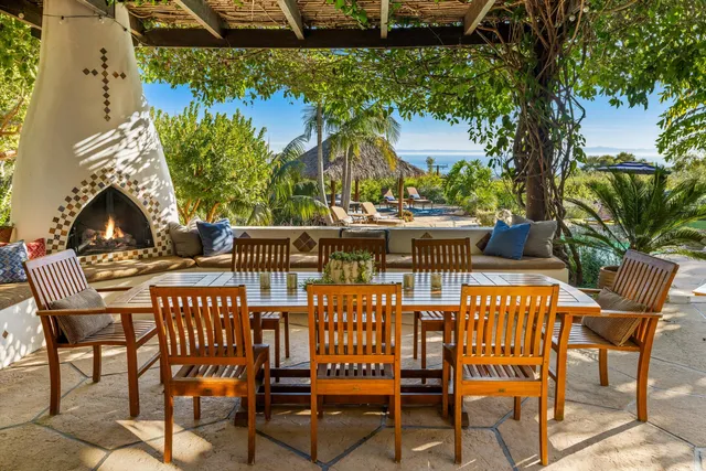 a view of a chairs and table in patio