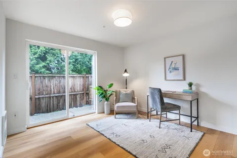 a living room with furniture and a potted plant
