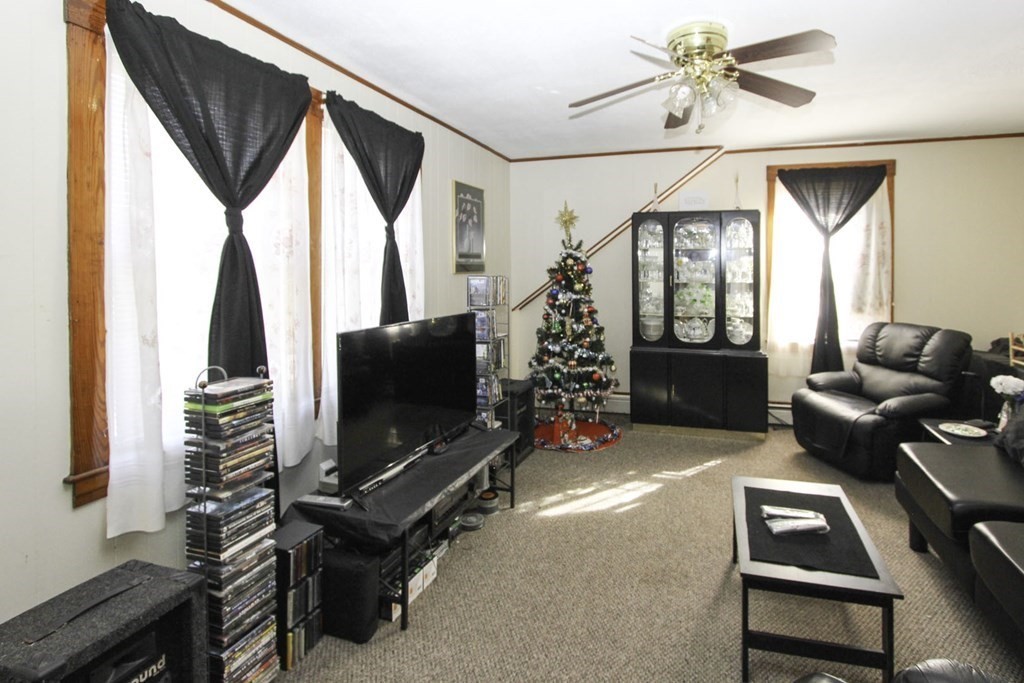 68 Bemis Road Fitchburg, MA 01420 - Photo 1 of 21 a living room with furniture a flat screen tv and a floor to ceiling window