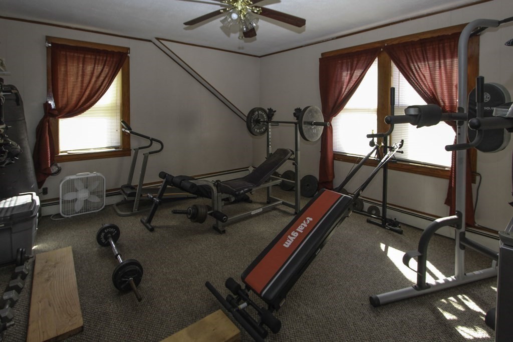 68 Bemis Road Fitchburg, MA 01420 - Photo 5 of 21 a room with gym equipment and a large mirror