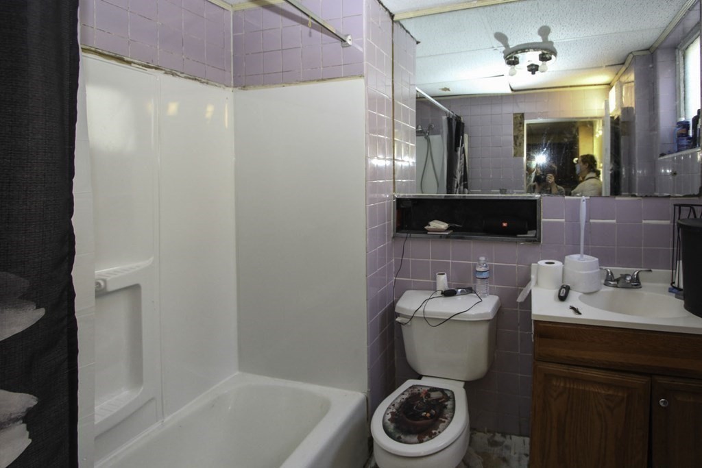 68 Bemis Road Fitchburg, MA 01420 - Photo 8 of 21 a bathroom with a sink a toilet and a mirror