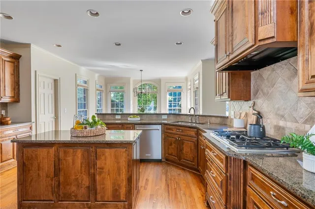 a view of a tennis ground with large trees