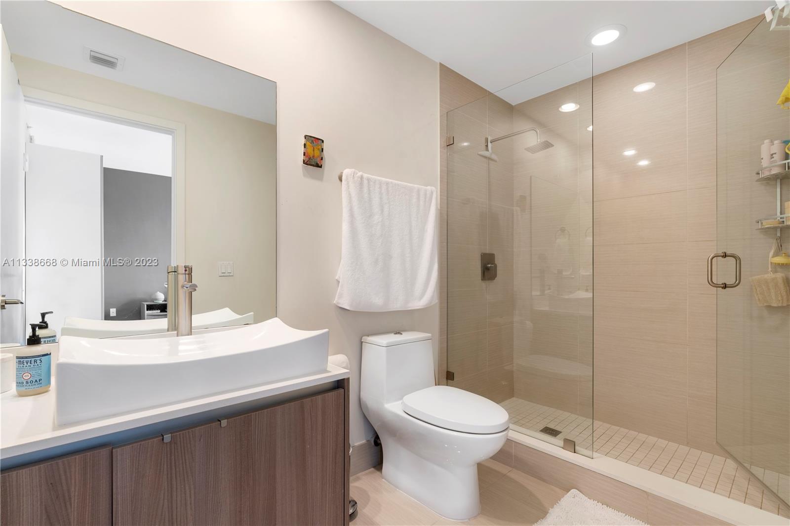 201 Southwest 17th Road, Unit 501 Miami, FL 33129 - Photo 17 of 20 a bathroom with a sink a toilet and shower