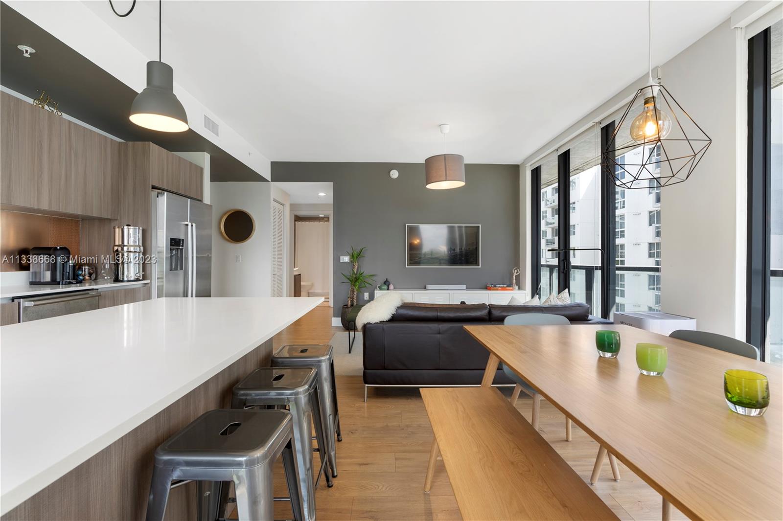 201 Southwest 17th Road, Unit 501 Miami, FL 33129 - Photo 3 of 20 a large kitchen with kitchen island a large counter top space a sink stainless steel appliances and cabinets