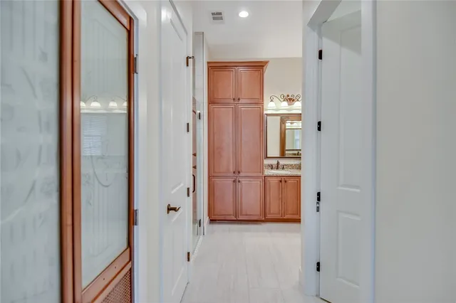 a view of a hallway with wooden shelves