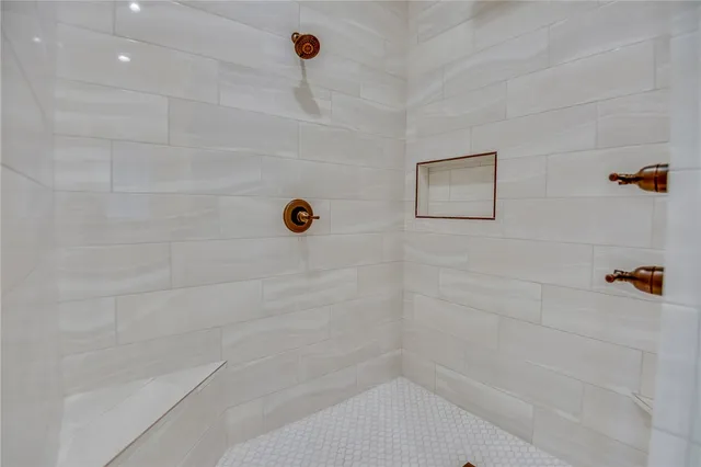 a bathroom with a glass shower door