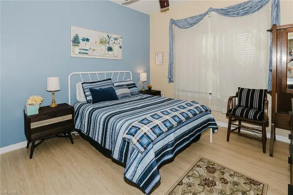 a bedroom with bed and a chair