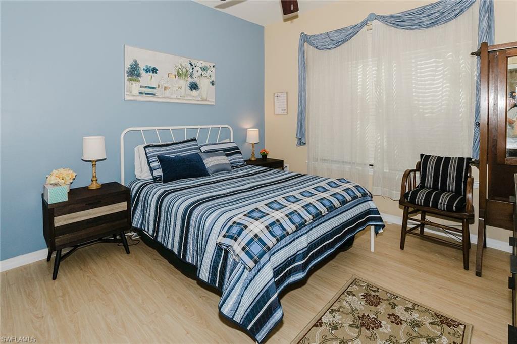 6441 Liberty Street Ave Maria, FL 34142 - Photo 11 of 48 a bedroom with bed and a chair