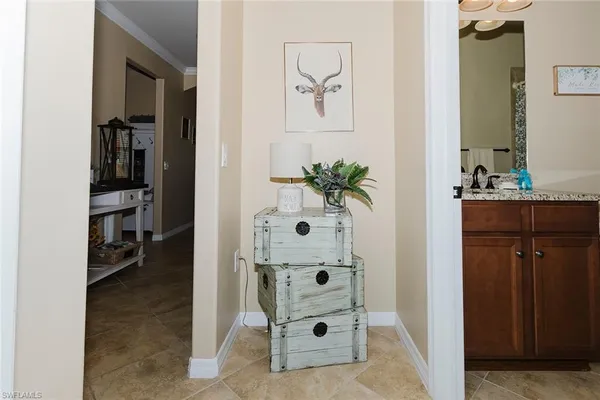 a bathroom with a granite countertop toilet and a sink