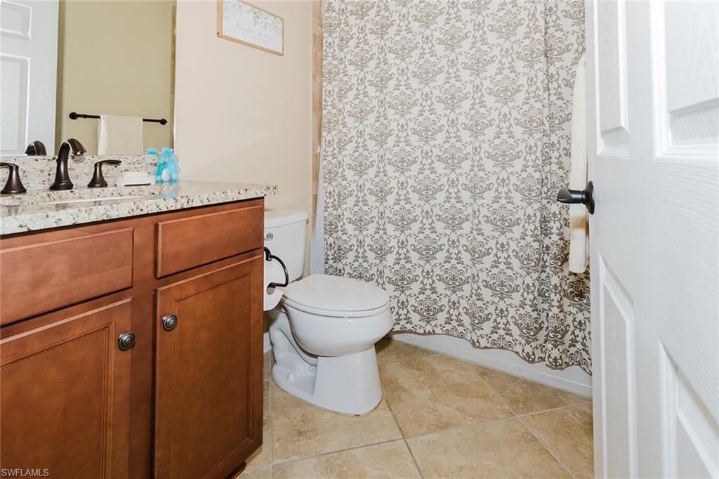 6441 Liberty Street Ave Maria, FL 34142 - Photo 14 of 48 a bathroom with a granite countertop toilet and a sink