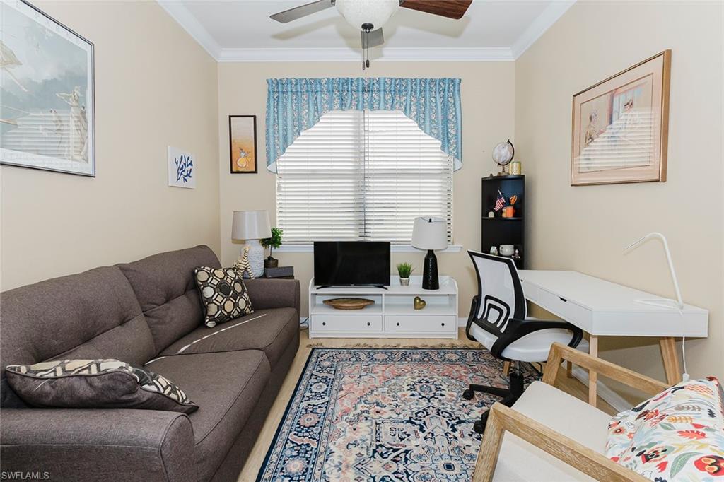 6441 Liberty Street Ave Maria, FL 34142 - Photo 15 of 48 a living room with furniture a couch and a chandelier
