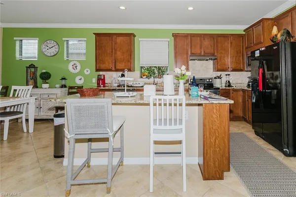a kitchen with stainless steel appliances granite countertop lots of counter top space and wooden floor