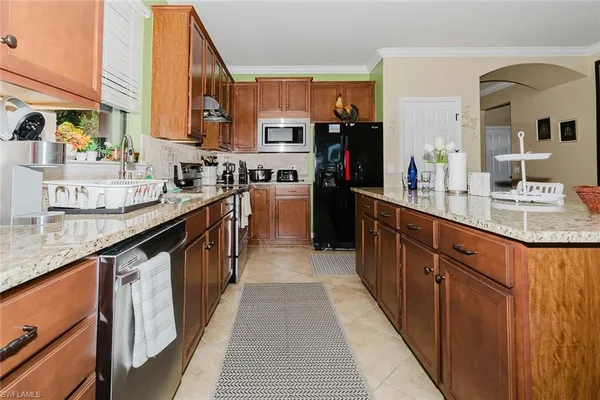 a kitchen with sink a counter top space and cabinets