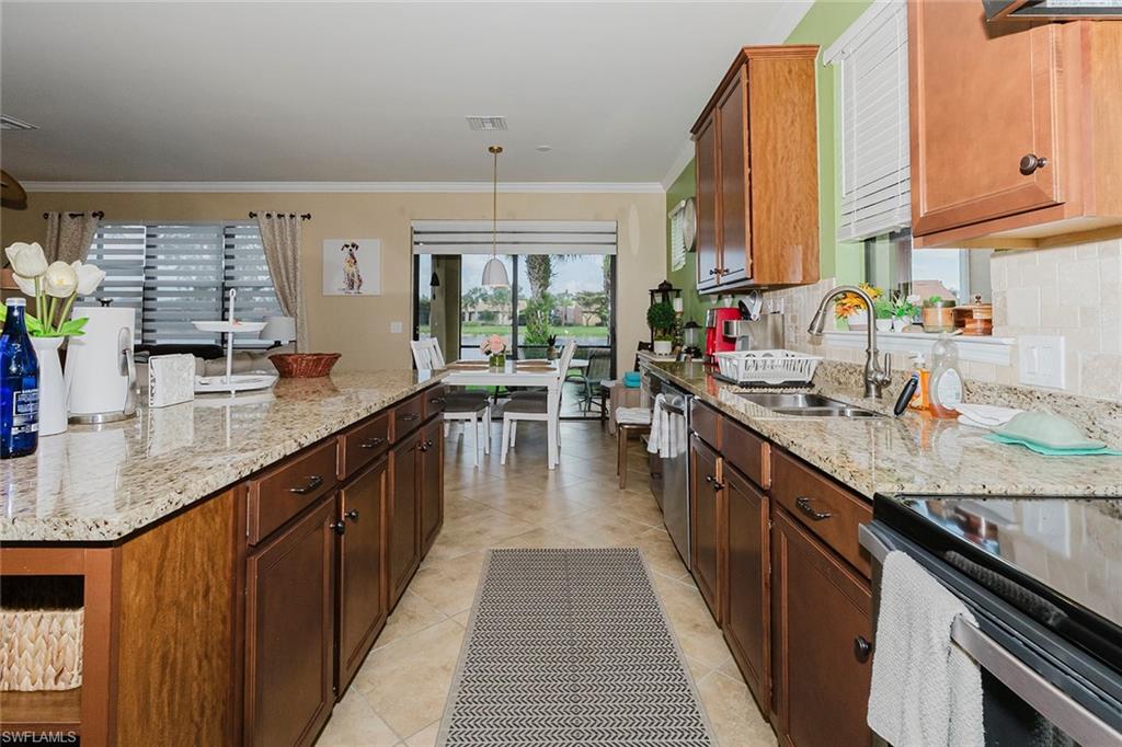 6441 Liberty Street Ave Maria, FL 34142 - Photo 19 of 48 a kitchen with sink a counter top space and cabinets