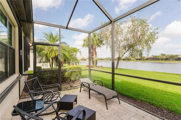 a view of a chairs and table in patio with a yard