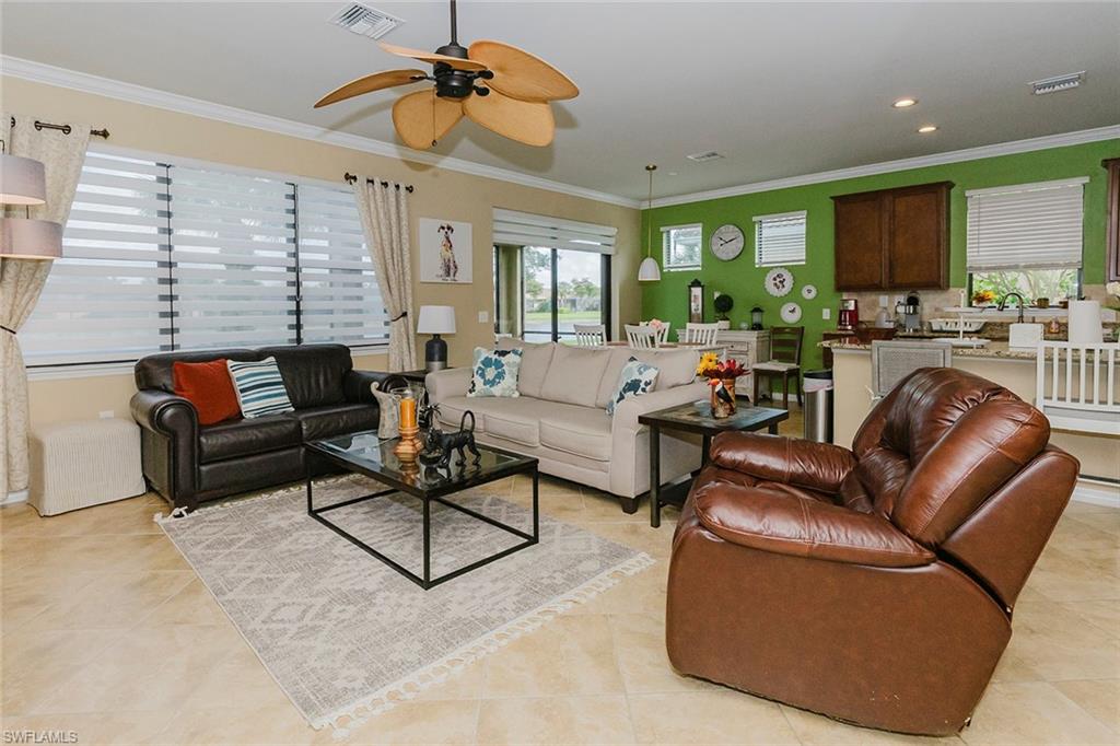 6441 Liberty Street Ave Maria, FL 34142 - Photo 22 of 48 a living room with furniture ceiling fan and a rug